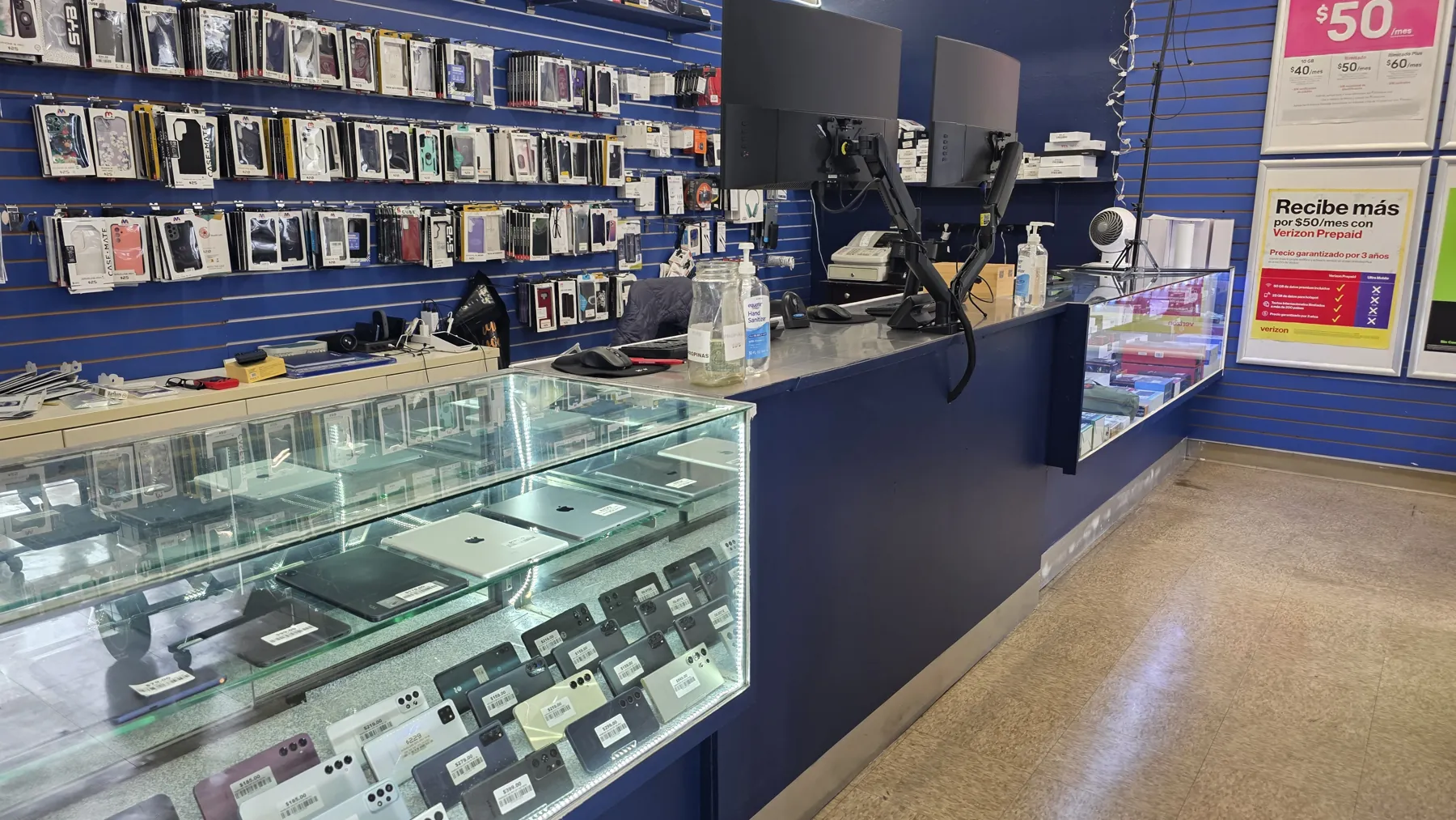 Inside Go Cellular: phone display case and accessories wall